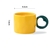 Ceramic cup with a heart - shaped handle